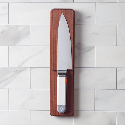 Wireless charging tile being mounted on the wall of a kitchen backsplash.