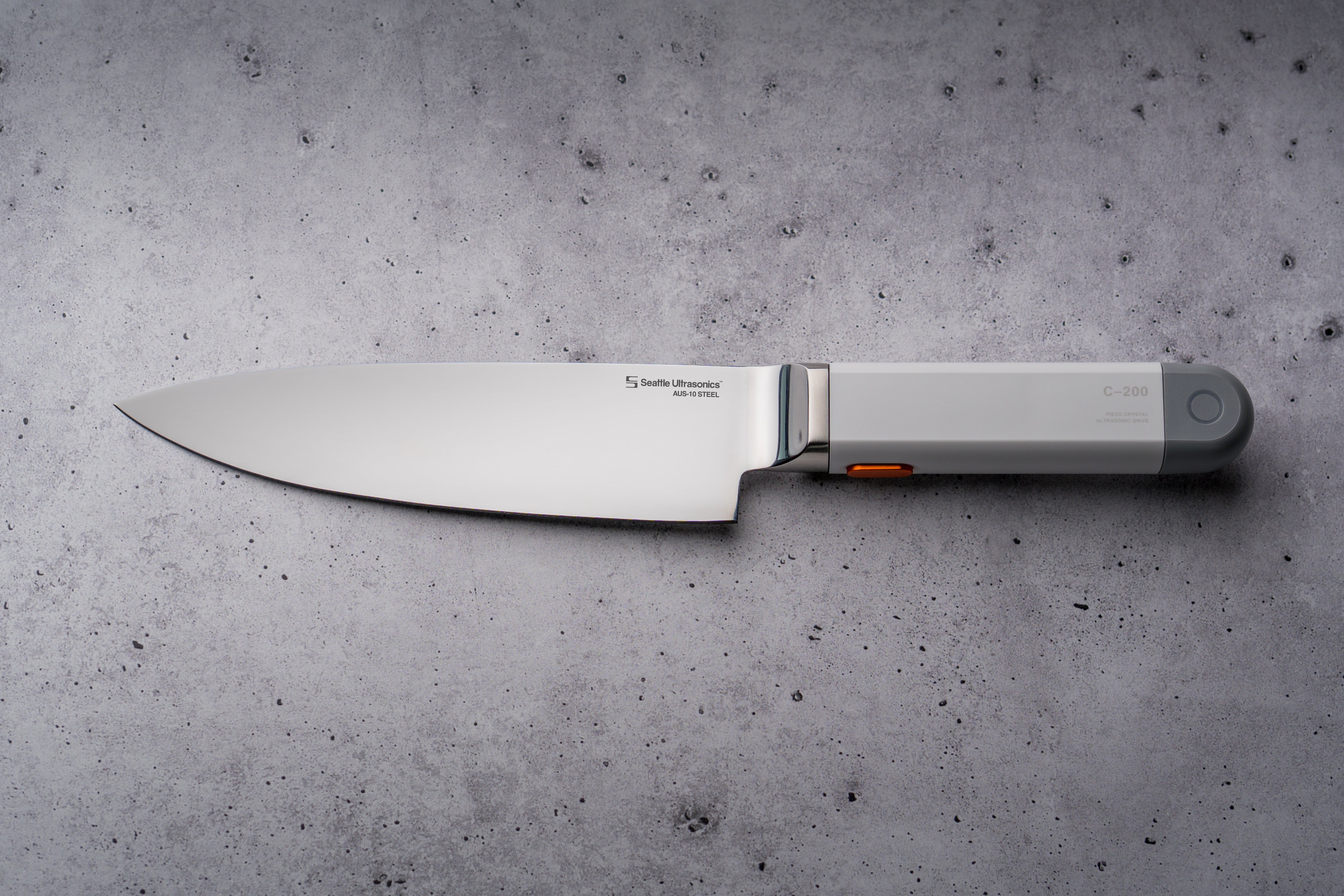 C-200 Ultrasonic Chef's Knife on a gray concrete surface