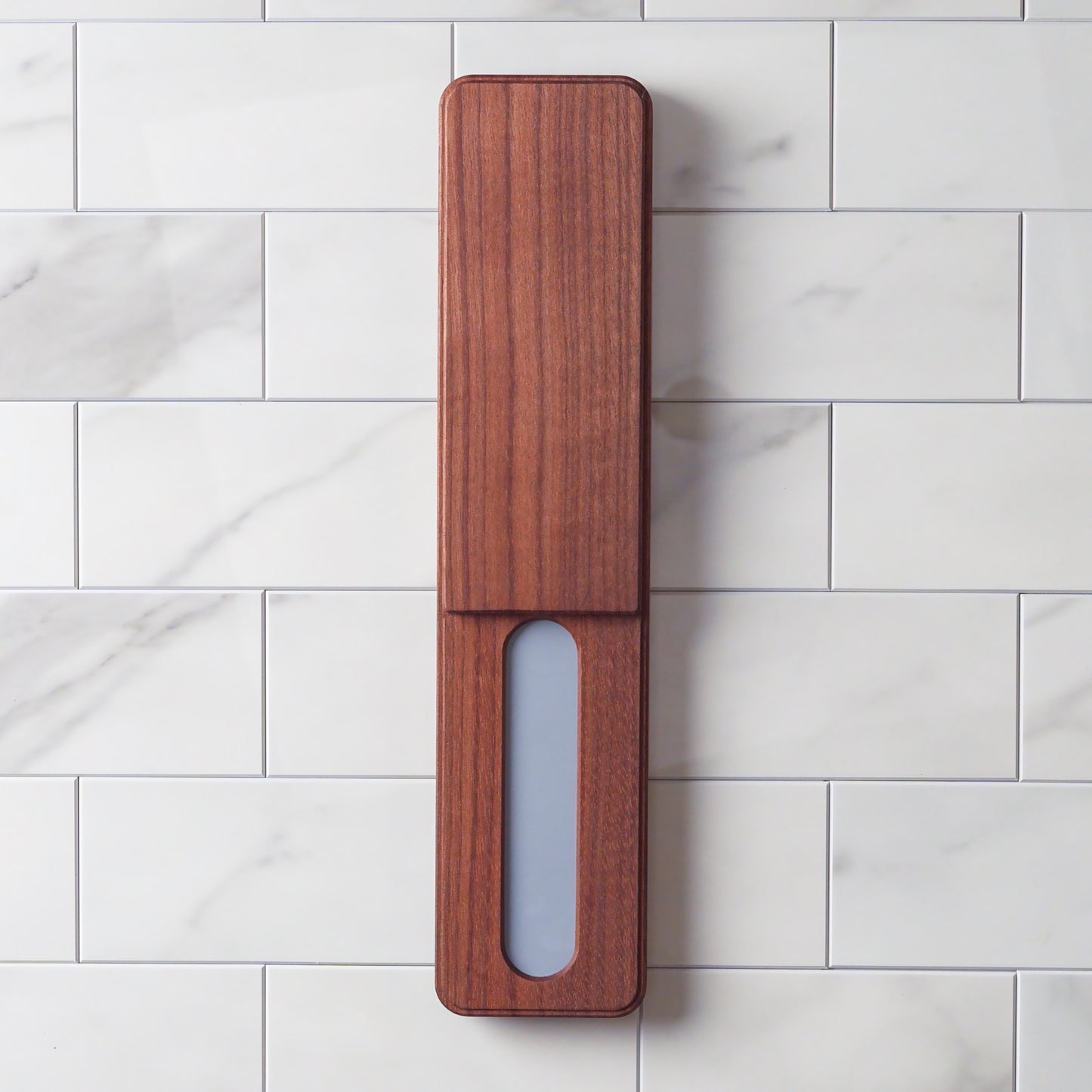 Wooden knife charger pad on a marble surface