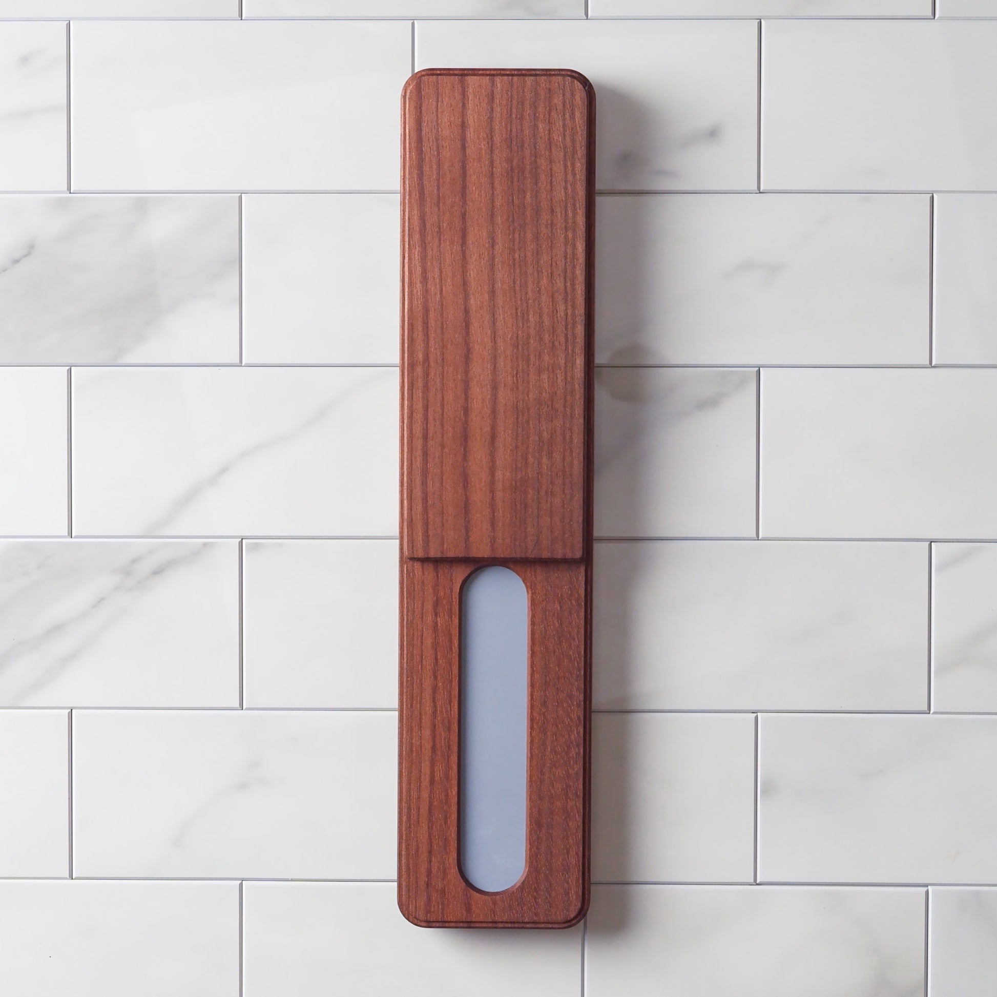 Wooden knife charger pad on a marble surface