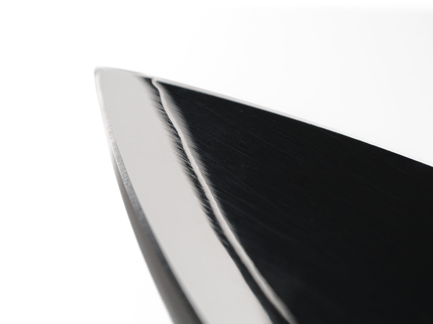 Close up of ultrasonic knife blade tip showing construction of Japanese san-mai three layer steel